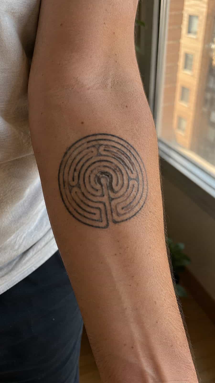 Modern Spartan: 18 Greek Tattoo Ideas Every Man Should Consider 40 Healed the labyrinth tattoo on a adult man's inner forearm, photographed in a natural slightly elevated close view — study 3
