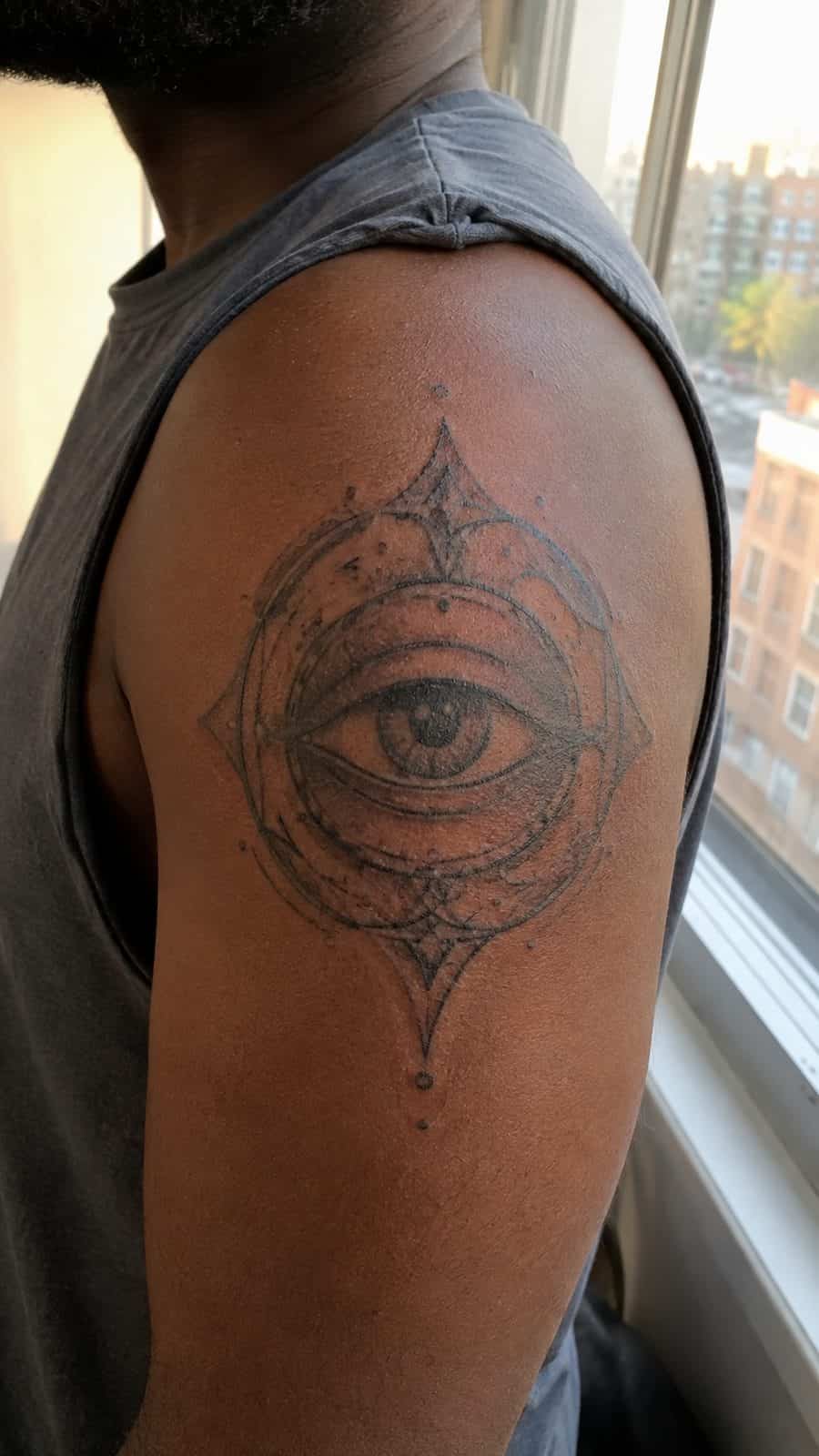 Modern Spartan: 18 Greek Tattoo Ideas Every Man Should Consider 41 Healed the oracle's eye tattoo on a adult man's shoulder, photographed in a natural slightly elevated close view — study 1