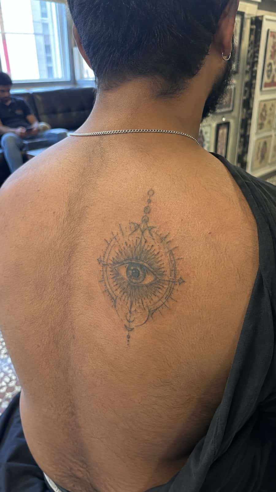Modern Spartan: 18 Greek Tattoo Ideas Every Man Should Consider 42 Healed the oracle's eye tattoo on a adult man's upper back, photographed in a natural waist-height candid close-up — study 2
