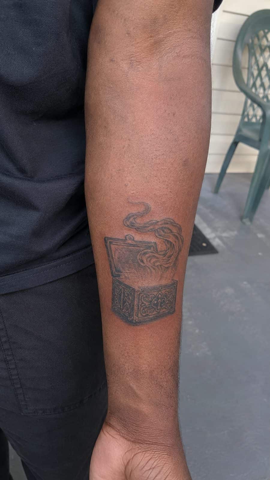 Modern Spartan: 18 Greek Tattoo Ideas Every Man Should Consider 43 Healed pandora's box tattoo on a adult man's inner forearm, photographed in a natural relaxed documentary crop — study 1