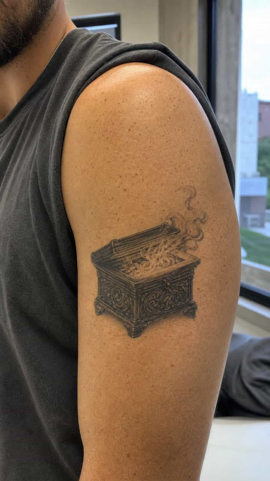 Modern Spartan: 18 Greek Tattoo Ideas Every Man Should Consider 45 Healed pandora's box tattoo on a adult man's outer upper arm, photographed in a natural straight-on close view, a touch off-center — study 3