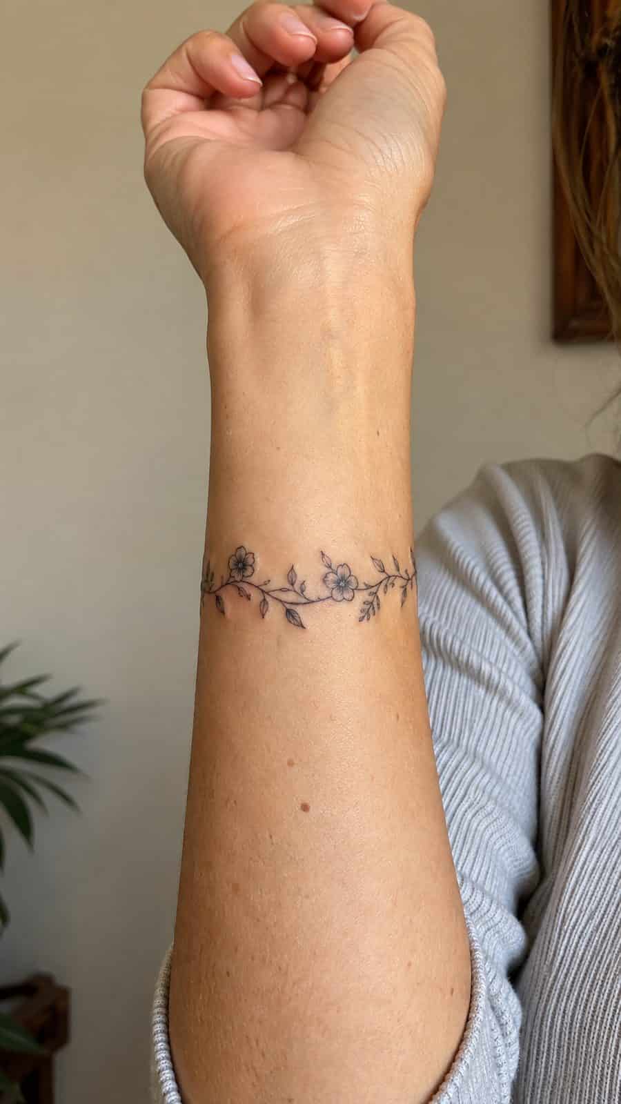Wrist Tattoos Women Are Raving About: Discover the 28 Most Gorgeous Designs 3 Healed delicate floral vine tattoo on a adult woman's inner wrist, photographed in a natural relaxed documentary crop — study 2