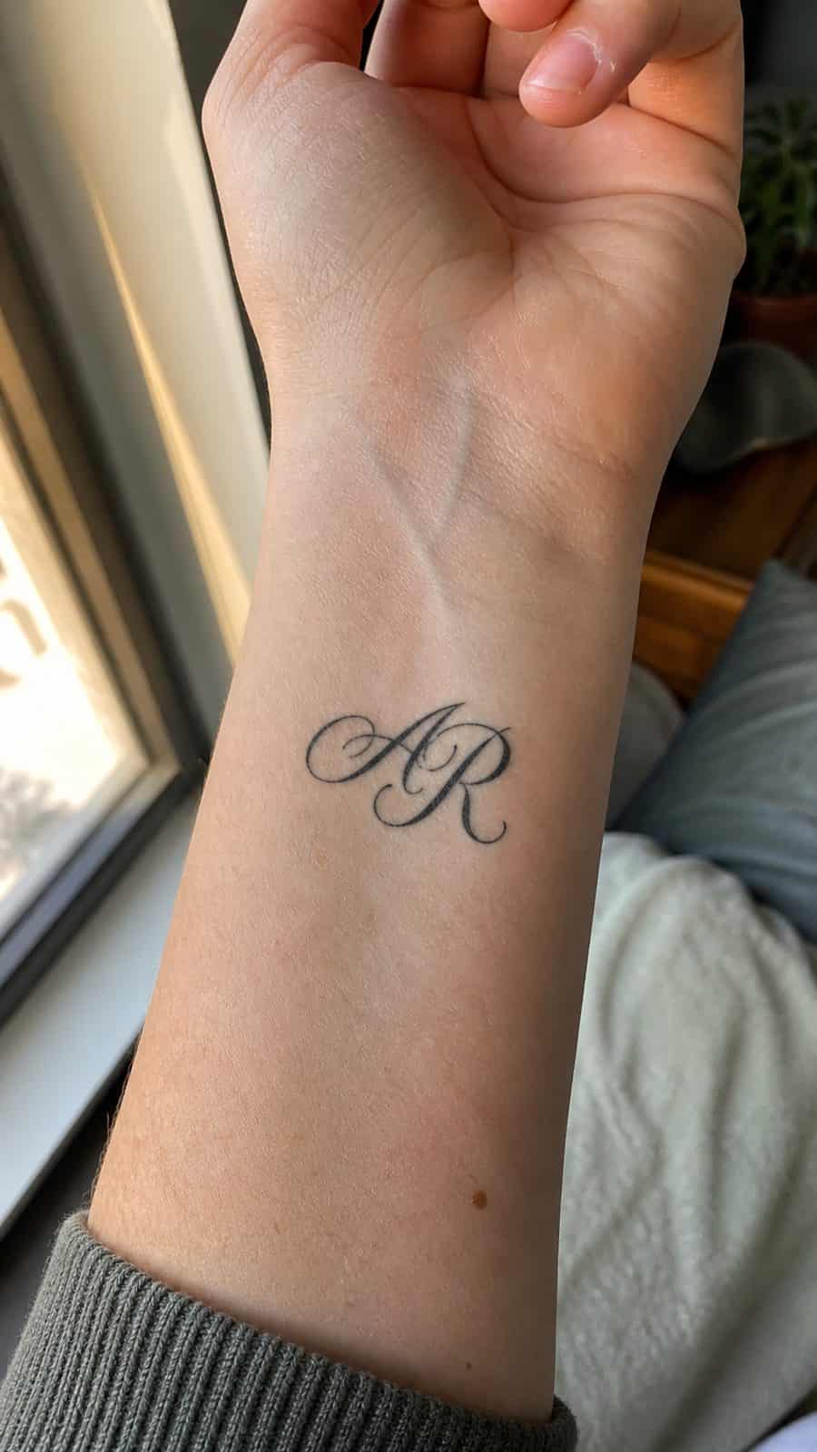 Wrist Tattoos Women Are Raving About: Discover the 28 Most Gorgeous Designs 9 Healed personalized initials in script tattoo on a adult woman's inner wrist, photographed in a natural slightly elevated close view — study 1