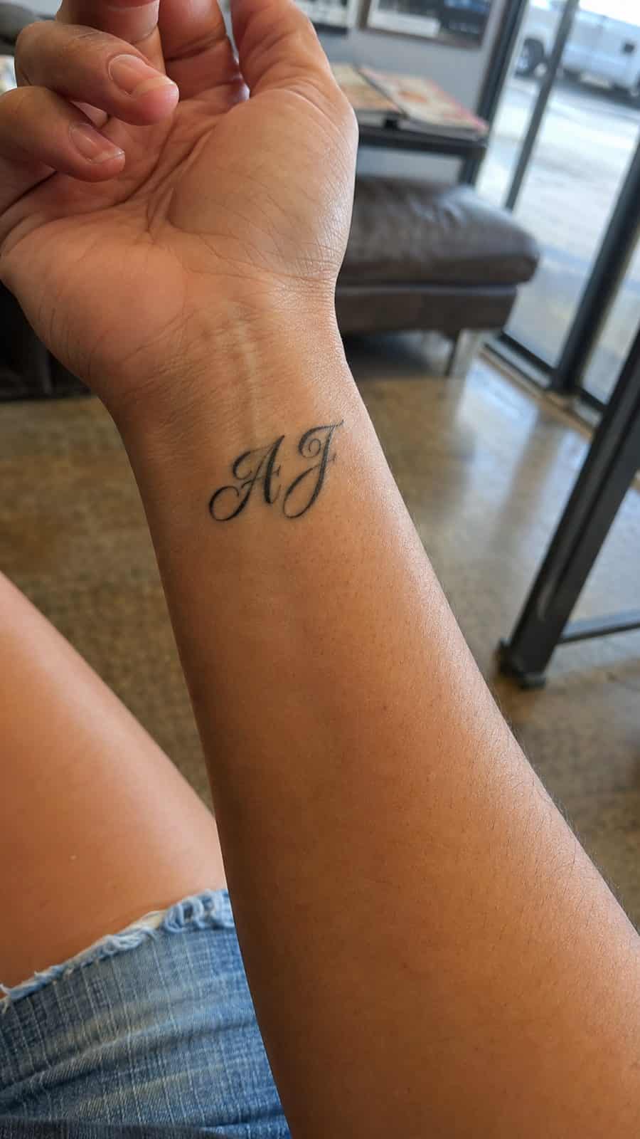 Wrist Tattoos Women Are Raving About: Discover the 28 Most Gorgeous Designs 10 Healed personalized initials in script tattoo on a adult woman's inner wrist, photographed in a natural waist-height candid close-up — study 2