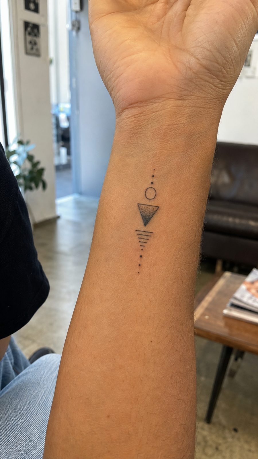 Wrist Tattoos Women Are Raving About: Discover the 28 Most Gorgeous Designs 14 Healed minimal geometric shapes tattoo on a adult woman's inner wrist, photographed in a natural straight-on close view, a touch — study 1