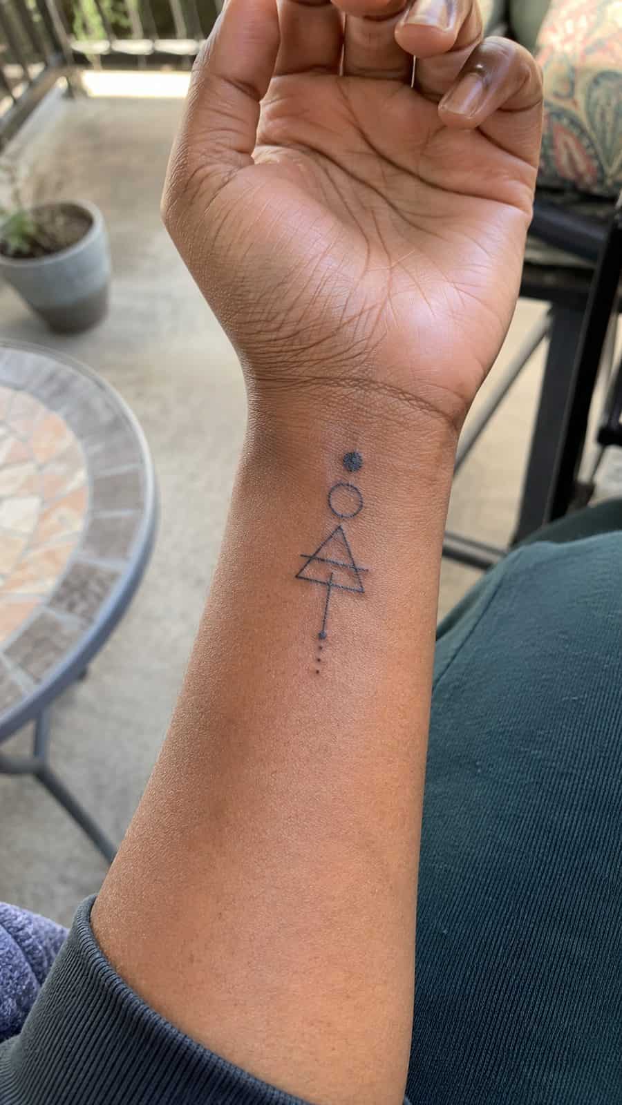 Wrist Tattoos Women Are Raving About: Discover the 28 Most Gorgeous Designs 16 Healed minimal geometric shapes tattoo on a adult woman's inner wrist, photographed in a natural slightly elevated close view — study 3