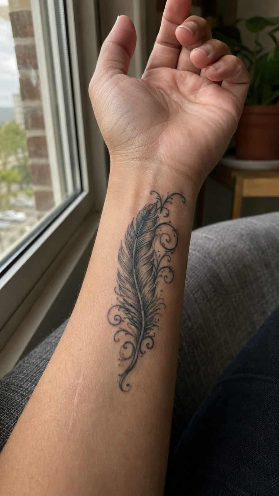 Wrist Tattoos Women Are Raving About: Discover the 28 Most Gorgeous Designs 19 Healed feather with scrollwork tattoo on a adult woman's inner wrist, photographed in a natural gentle side angle that clearly shows — study 1