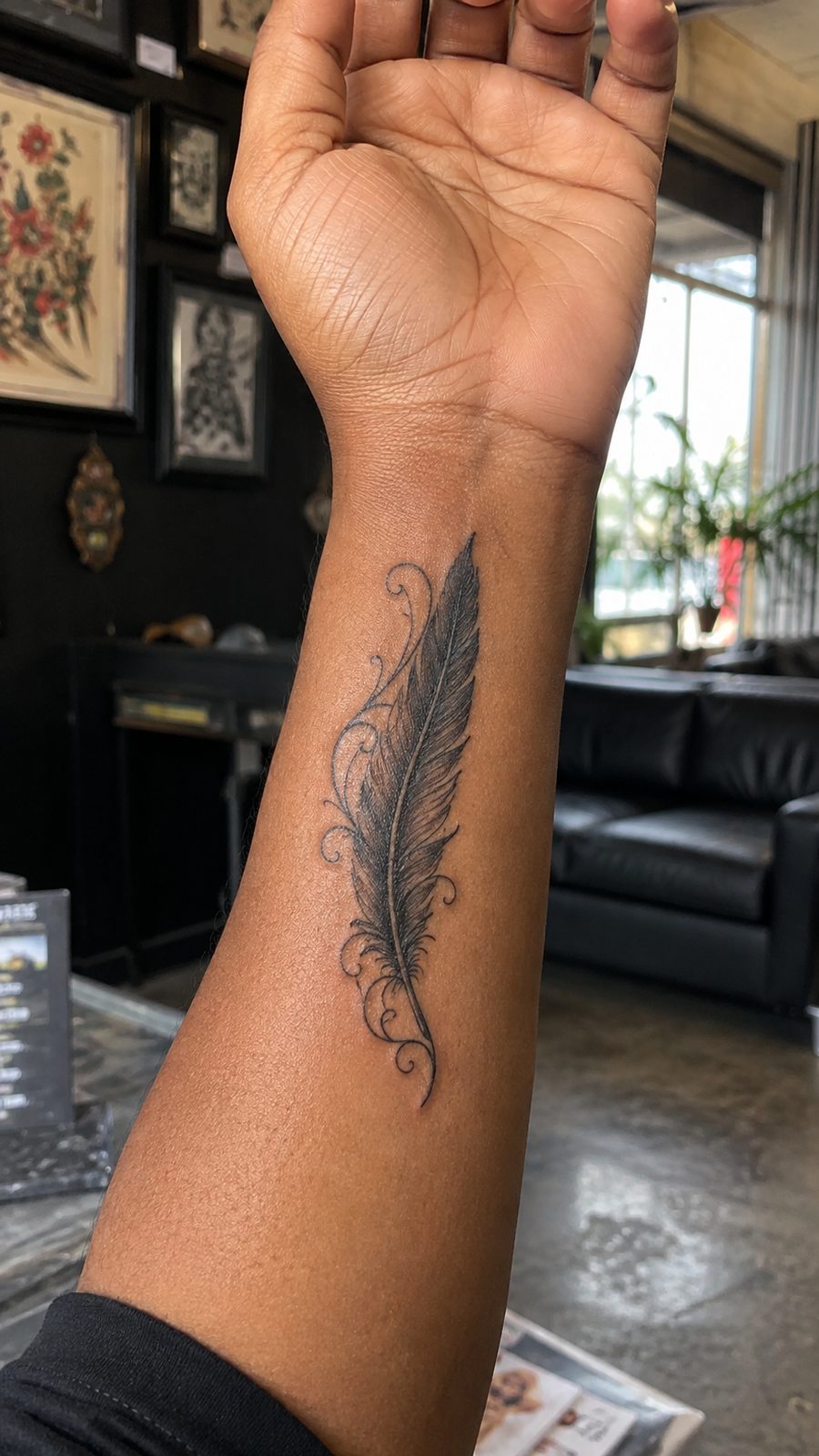 Wrist Tattoos Women Are Raving About: Discover the 28 Most Gorgeous Designs 20 Healed feather with scrollwork tattoo on a adult woman's inner wrist, photographed in a natural slightly elevated close view — study 2