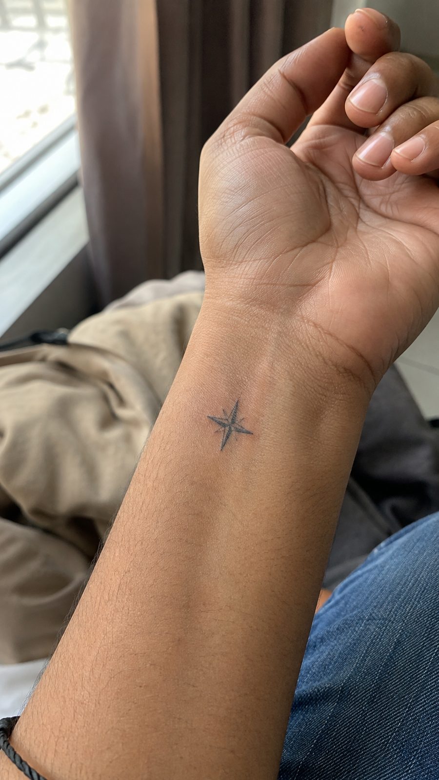 Wrist Tattoos Women Are Raving About: Discover the 28 Most Gorgeous Designs 23 Healed small compass design tattoo on a adult woman's inner wrist, photographed in a natural slightly elevated close view — study 3