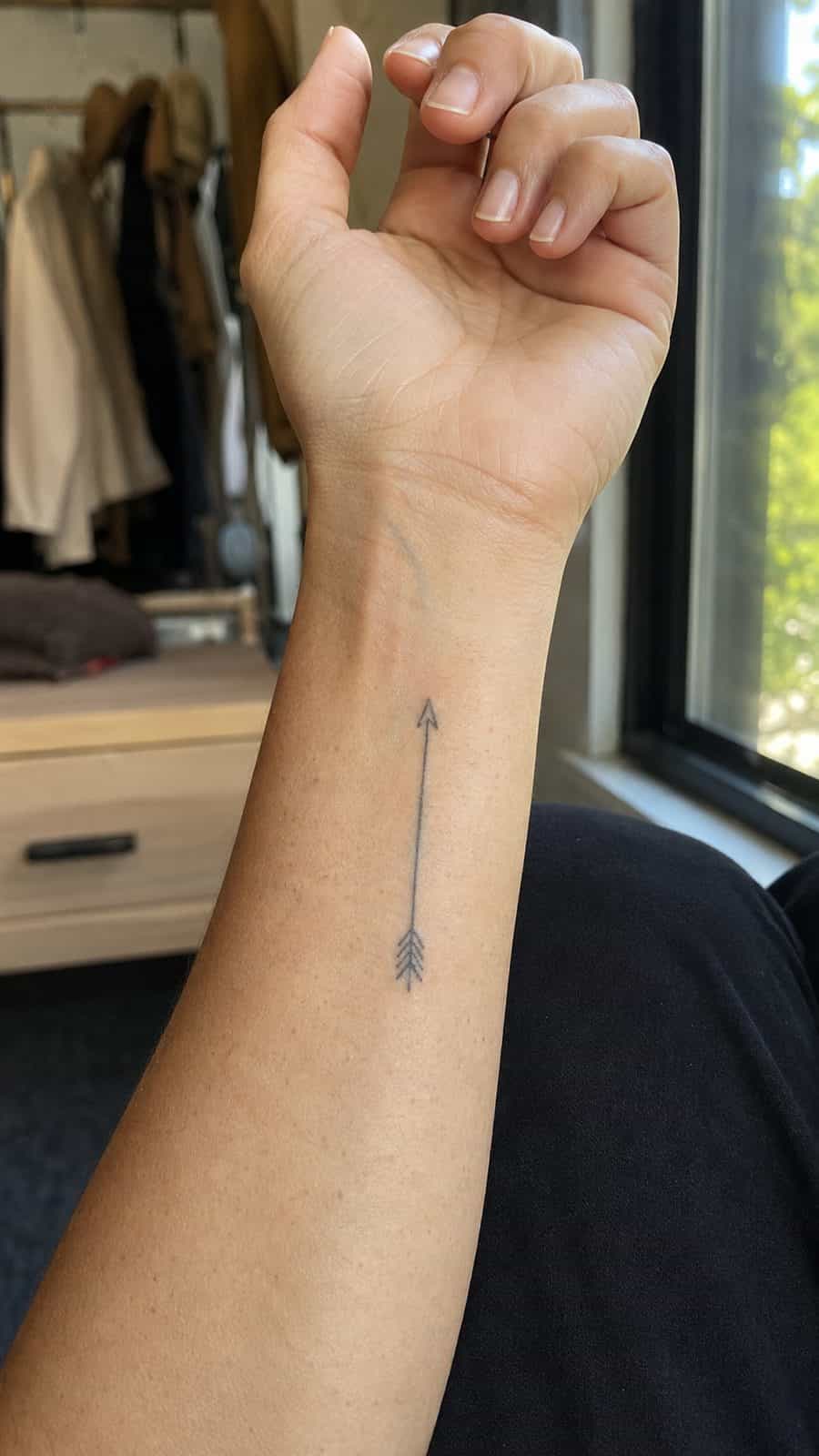 Wrist Tattoos Women Are Raving About: Discover the 28 Most Gorgeous Designs 27 Healed subtle arrow line tattoo on a adult woman's inner wrist, photographed in a natural straight-on close view, a touch off-center — study 1