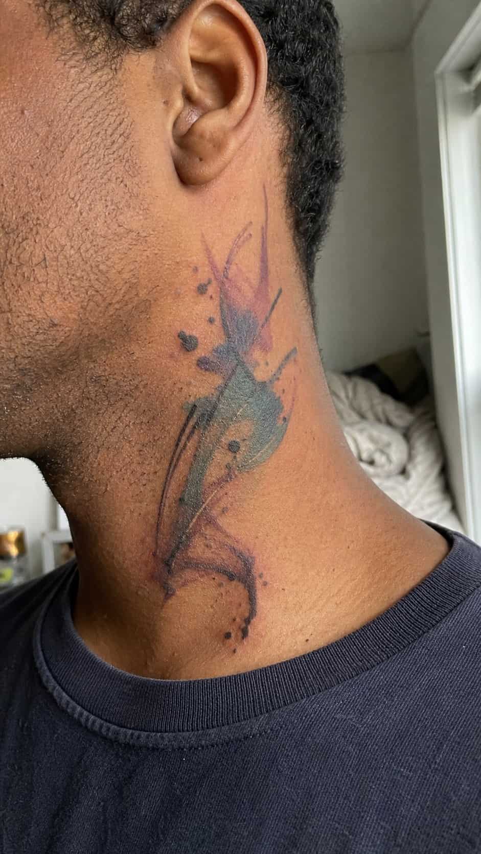 15 Neck Tattoo Ideas for Men Worth Considering 7 Healed abstract watercolors tattoo on a adult man's side neck, photographed in a natural straight-on close view, a touch off-center — study 1