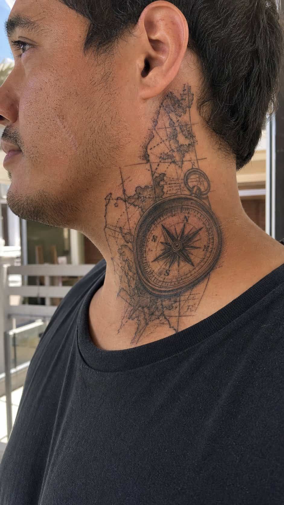 15 Neck Tattoo Ideas for Men Worth Considering 12 Healed vintage compass and map tattoo on a adult man's side neck, photographed in a natural relaxed documentary crop — study 2