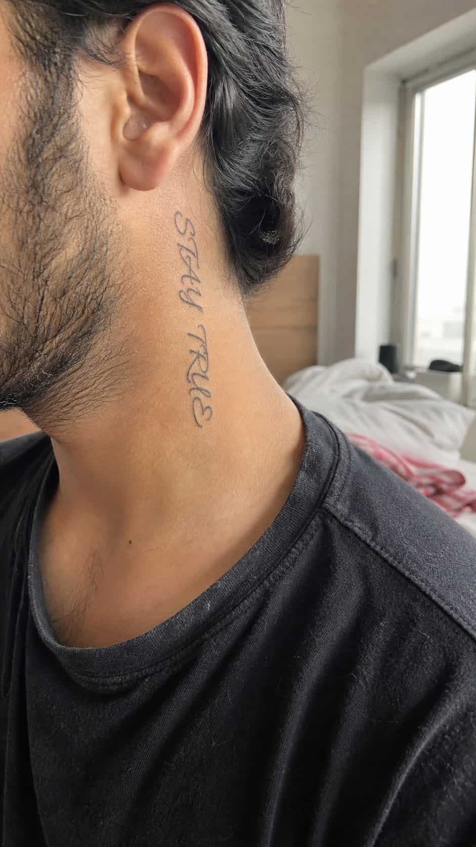 15 Neck Tattoo Ideas for Men Worth Considering 23 Healed cultural calligraphy tattoo on a adult man's side neck, photographed in a natural waist-height candid close-up — study 1