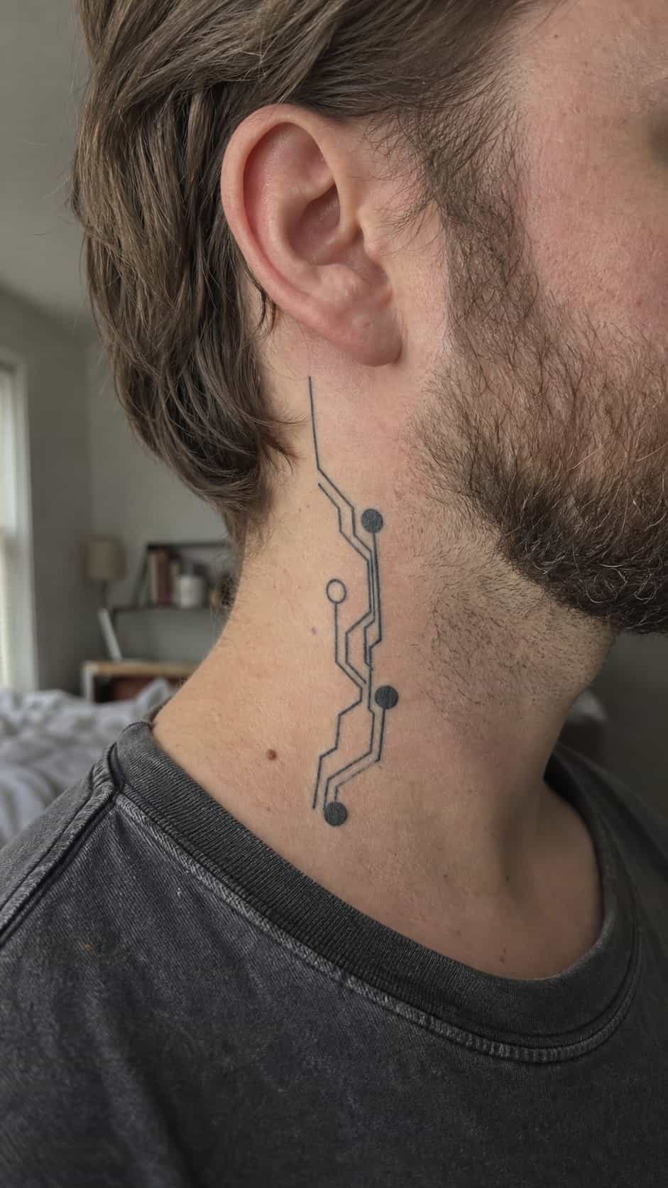 15 Neck Tattoo Ideas for Men Worth Considering 27 Healed futuristic tech design tattoo on a adult man's side neck, photographed in a natural straight-on close view, a touch off-center — study 1