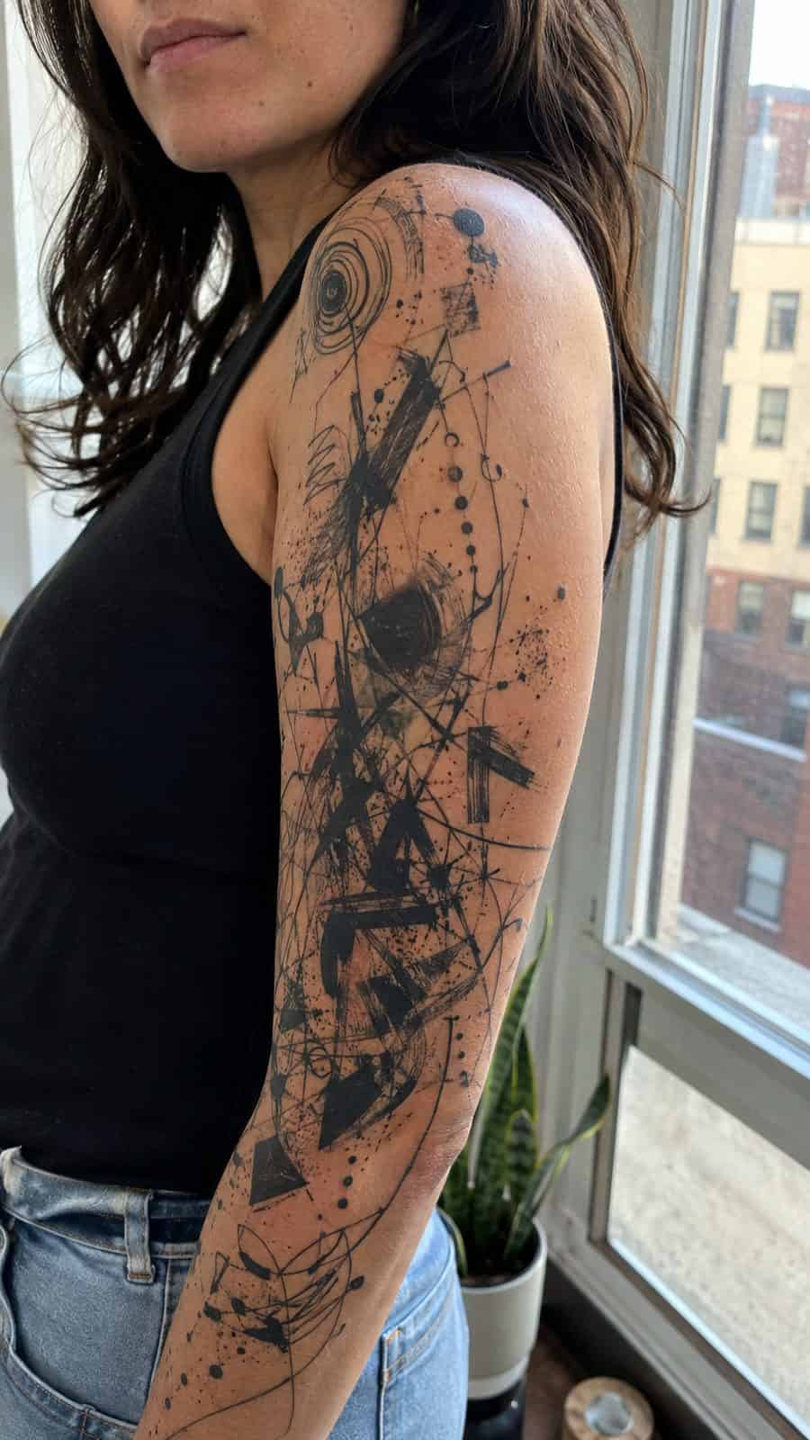 20 Edgy Grunge Tattoo Ideas for Women Who Break the Rules 5 Healed abstract chaos sleeve tattoo on a adult woman's upper-arm sleeve, photographed in a natural straight-on close view, a touch — study 2