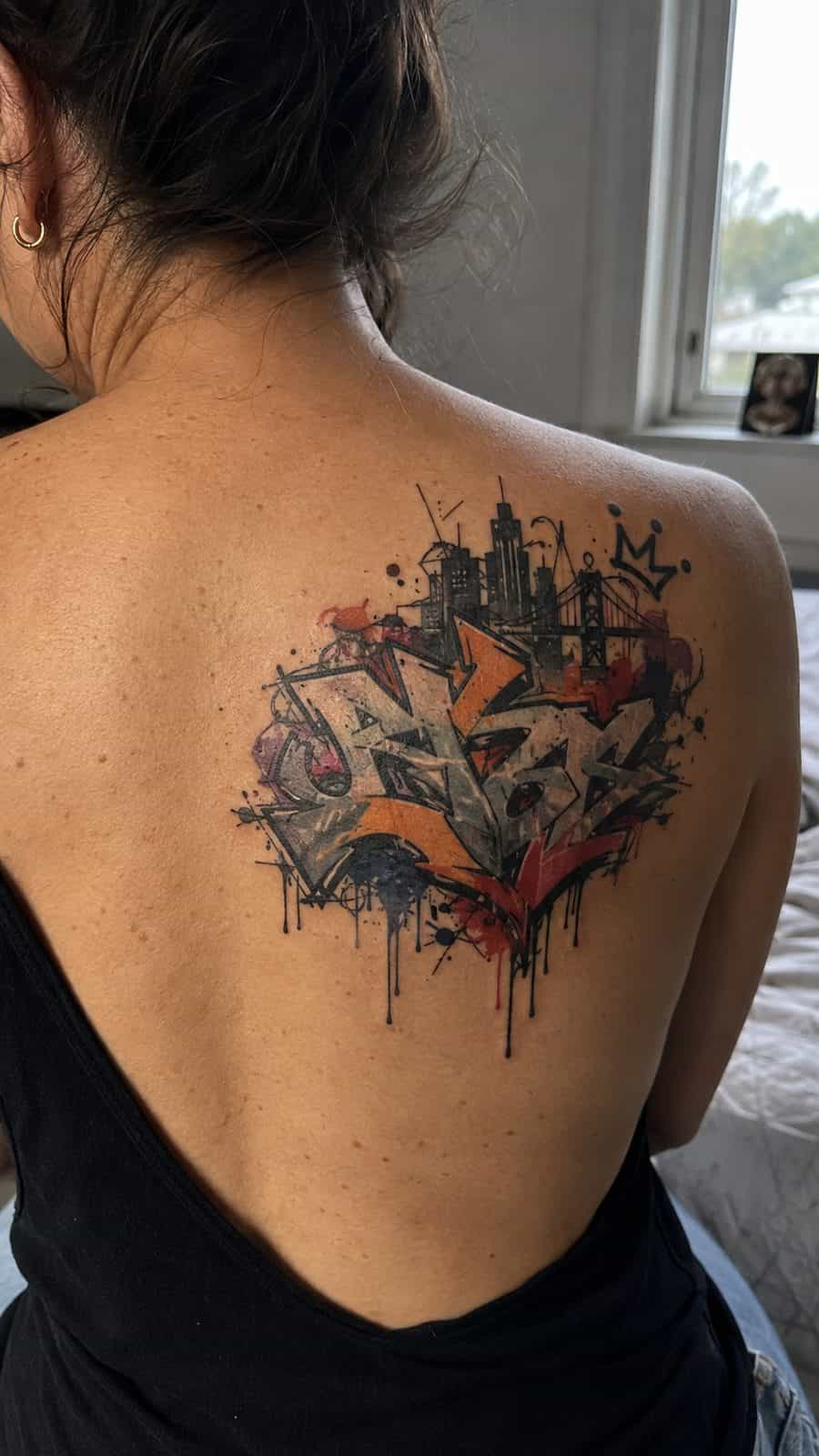20 Edgy Grunge Tattoo Ideas for Women Who Break the Rules 15 Healed urban graffiti elements tattoo on a adult woman's upper back, photographed in a natural straight-on close view, a touch — study 2