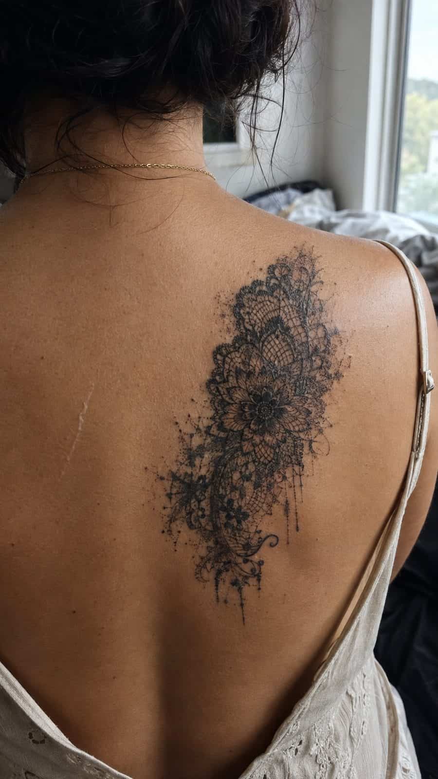 20 Edgy Grunge Tattoo Ideas for Women Who Break the Rules 20 Healed grunge lacework tattoo on a adult woman's upper back, photographed in a natural slightly elevated close view — study 3