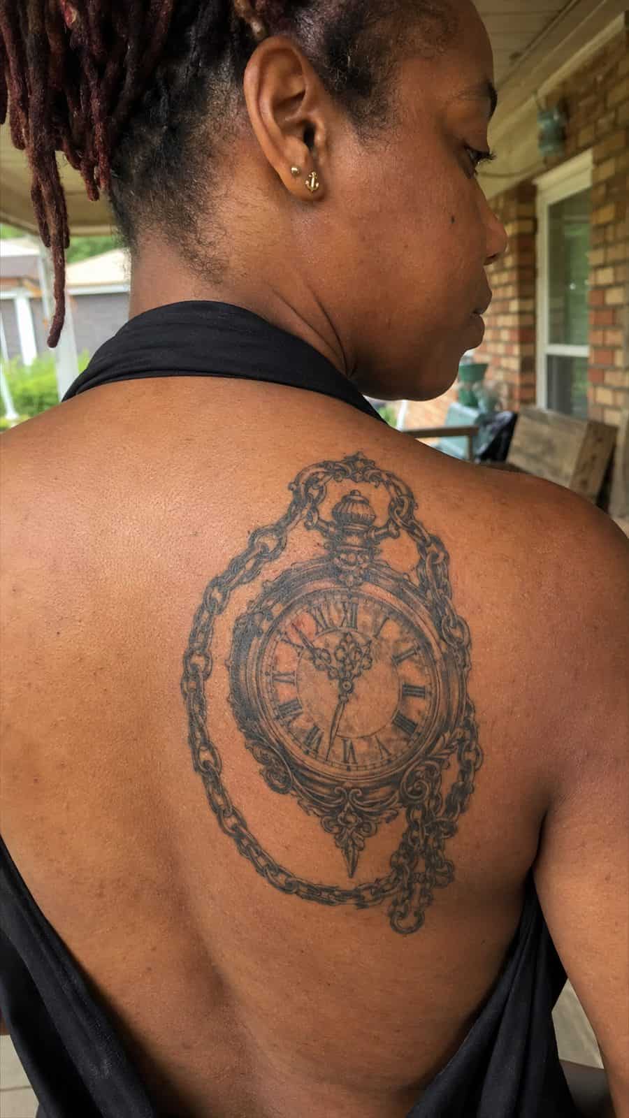 20 Edgy Grunge Tattoo Ideas for Women Who Break the Rules 27 Healed vintage clock with chains tattoo on a adult woman's upper back, photographed in a natural gentle side angle that clearly shows — study 2