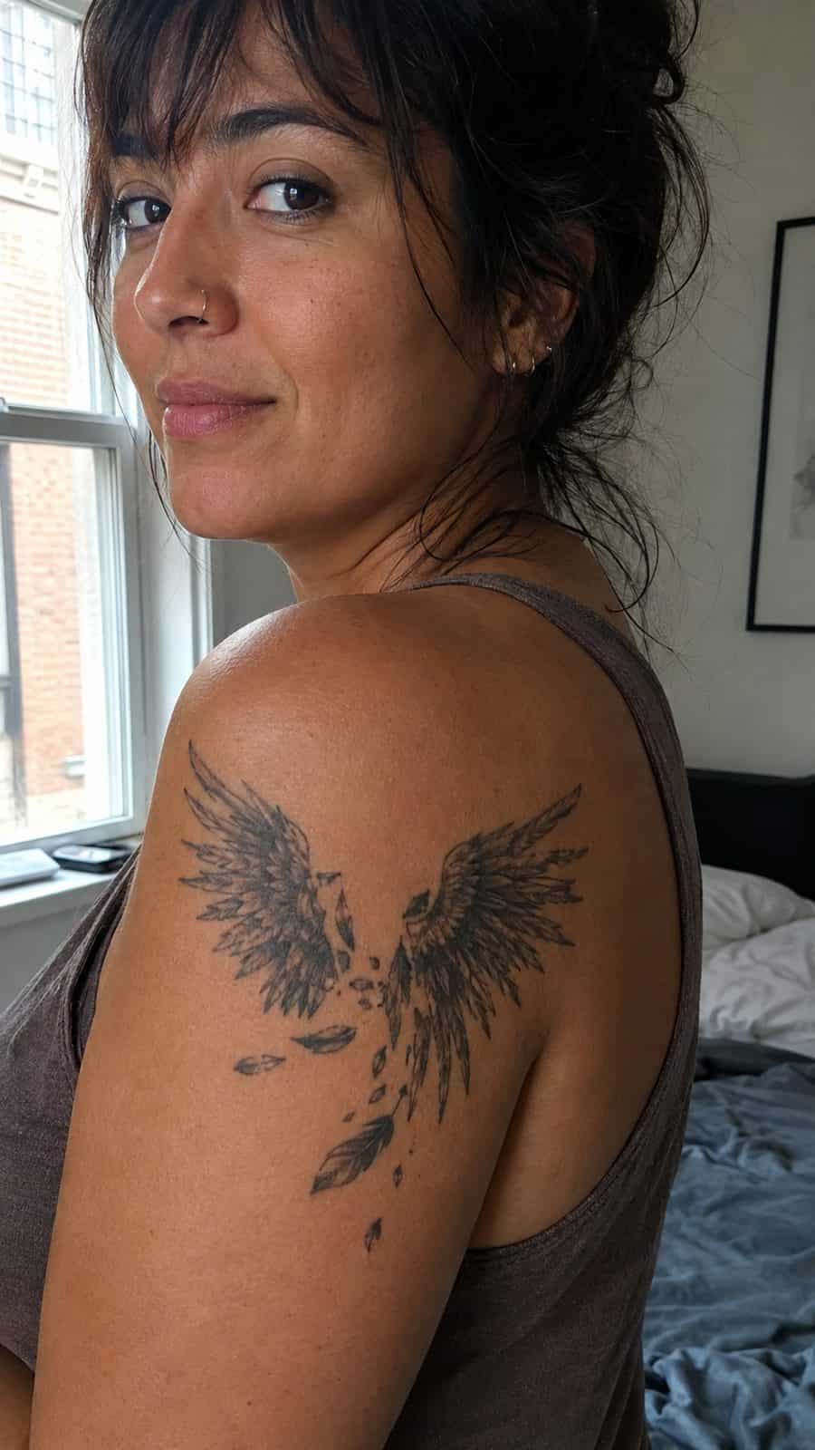 20 Edgy Grunge Tattoo Ideas for Women Who Break the Rules 28 Healed broken wings tattoo on a adult woman's shoulder, photographed in a natural waist-height candid close-up — study 1