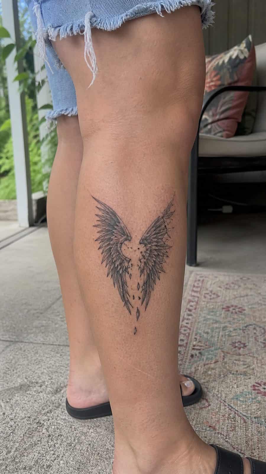 20 Edgy Grunge Tattoo Ideas for Women Who Break the Rules 29 Healed broken wings tattoo on a adult woman's outer calf, photographed in a natural relaxed documentary crop — study 2