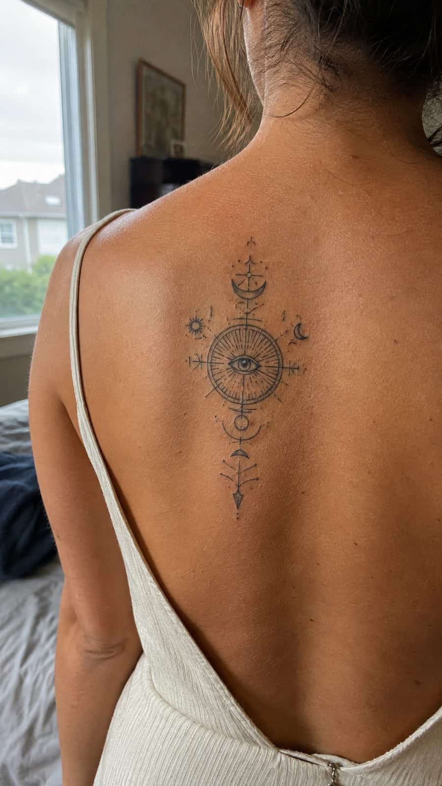 20 Edgy Grunge Tattoo Ideas for Women Who Break the Rules 32 Healed enigmatic symbols tattoo on a adult woman's upper back, photographed in a natural slightly elevated close view — study 1