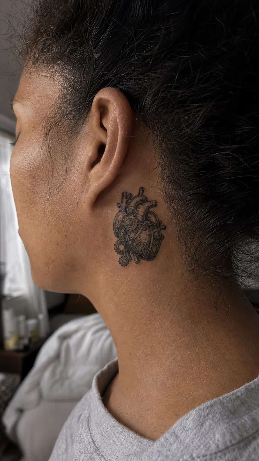 20 Edgy Grunge Tattoo Ideas for Women Who Break the Rules 35 Healed mechanical heart tattoo on a adult woman's behind the ear, photographed in a natural gentle side angle that clearly shows how — study 1