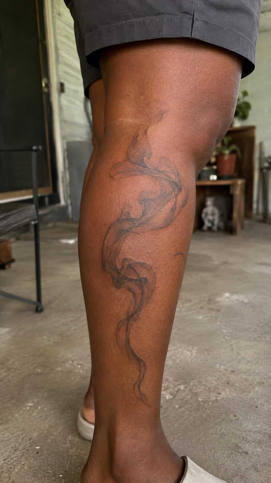 20 Edgy Grunge Tattoo Ideas for Women Who Break the Rules 37 Healed ethereal smoke tattoo on a adult woman's outer calf, photographed in a natural waist-height candid close-up — study 1