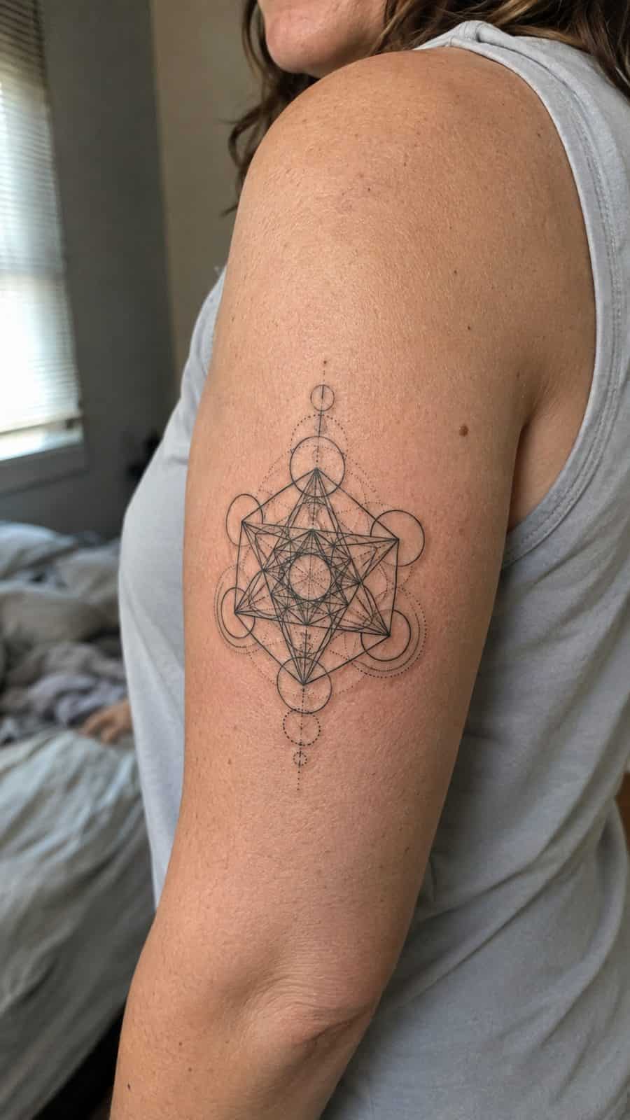 20 Edgy Grunge Tattoo Ideas for Women Who Break the Rules 40 Healed sacred geometry tattoo on a adult woman's outer upper arm, photographed in a natural relaxed documentary crop — study 1