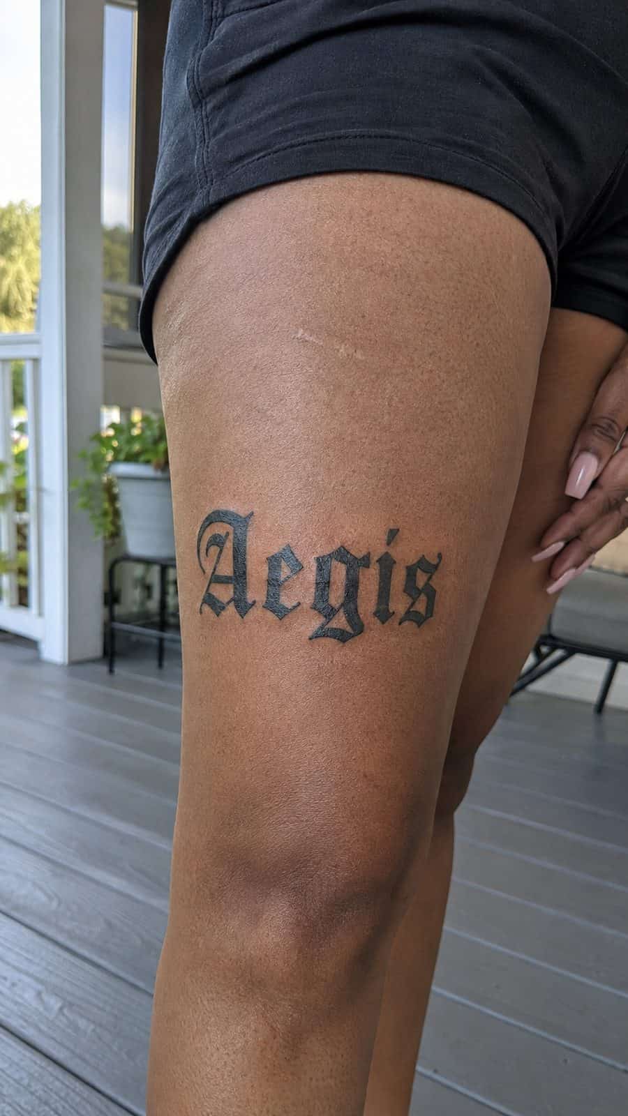 20 Edgy Grunge Tattoo Ideas for Women Who Break the Rules 47 Healed gothic letters tattoo on a adult woman's outer thigh, photographed in a natural straight-on close view, a touch off-center like — study 1