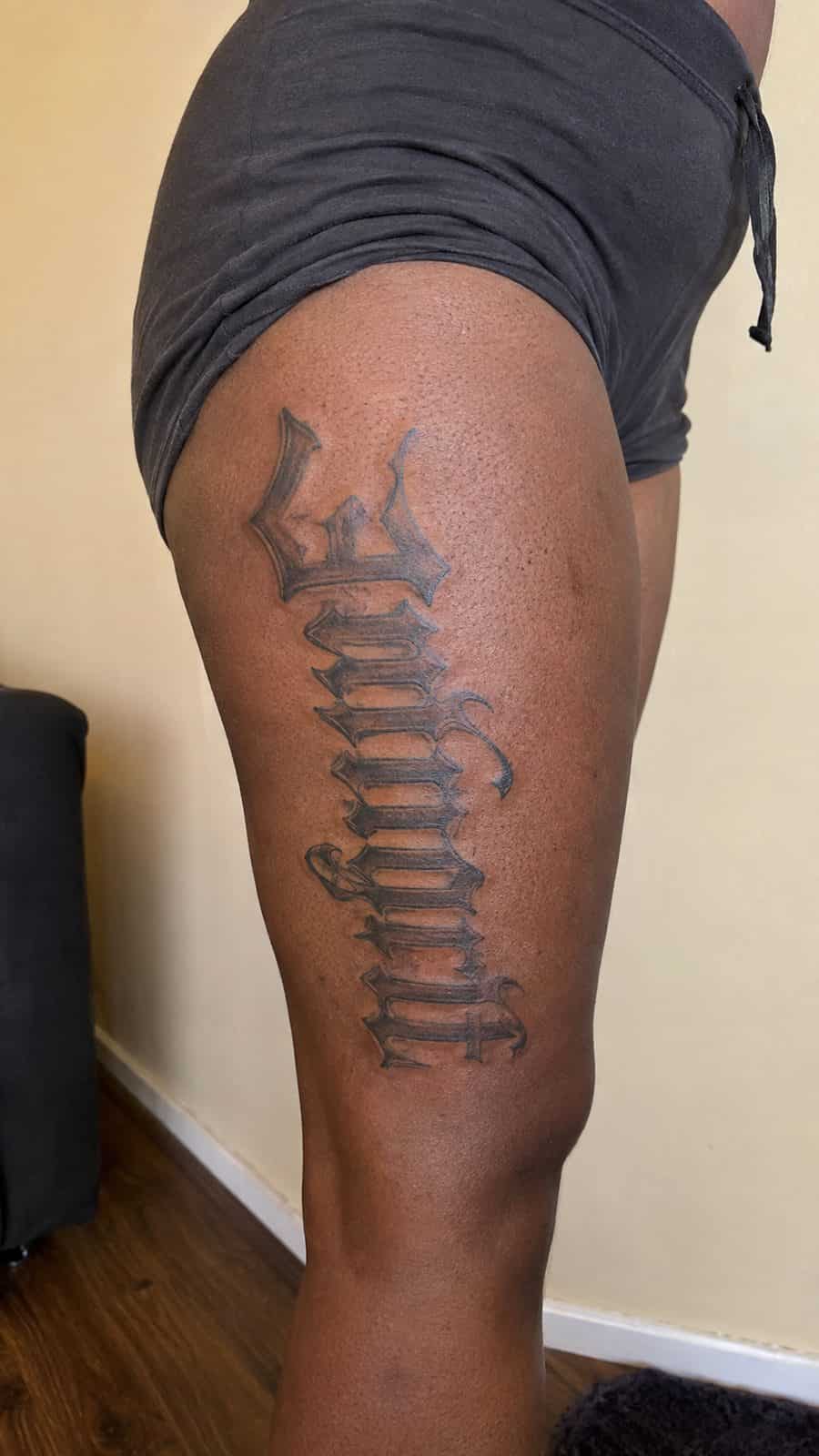 20 Edgy Grunge Tattoo Ideas for Women Who Break the Rules 48 Healed gothic letters tattoo on a adult woman's outer thigh, photographed in a natural gentle side angle that clearly shows how the — study 2