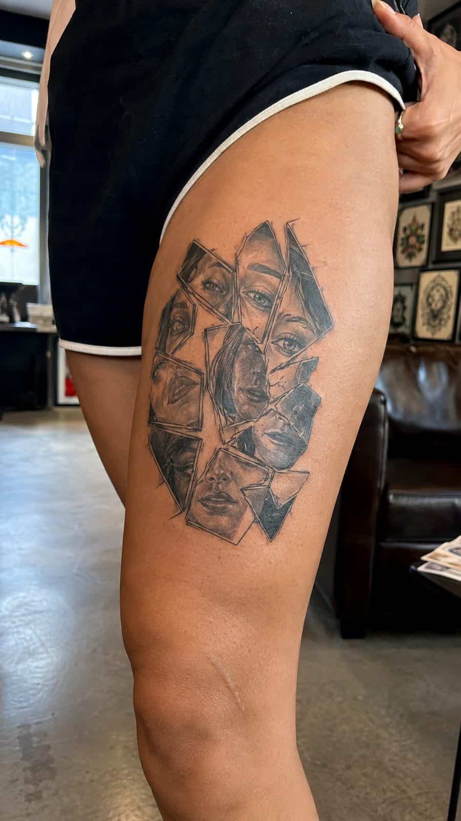 Healed broken mirror reflection tattoo on a adult person's outer thigh, photographed in a natural gentle side angle that clearly shows — study 1