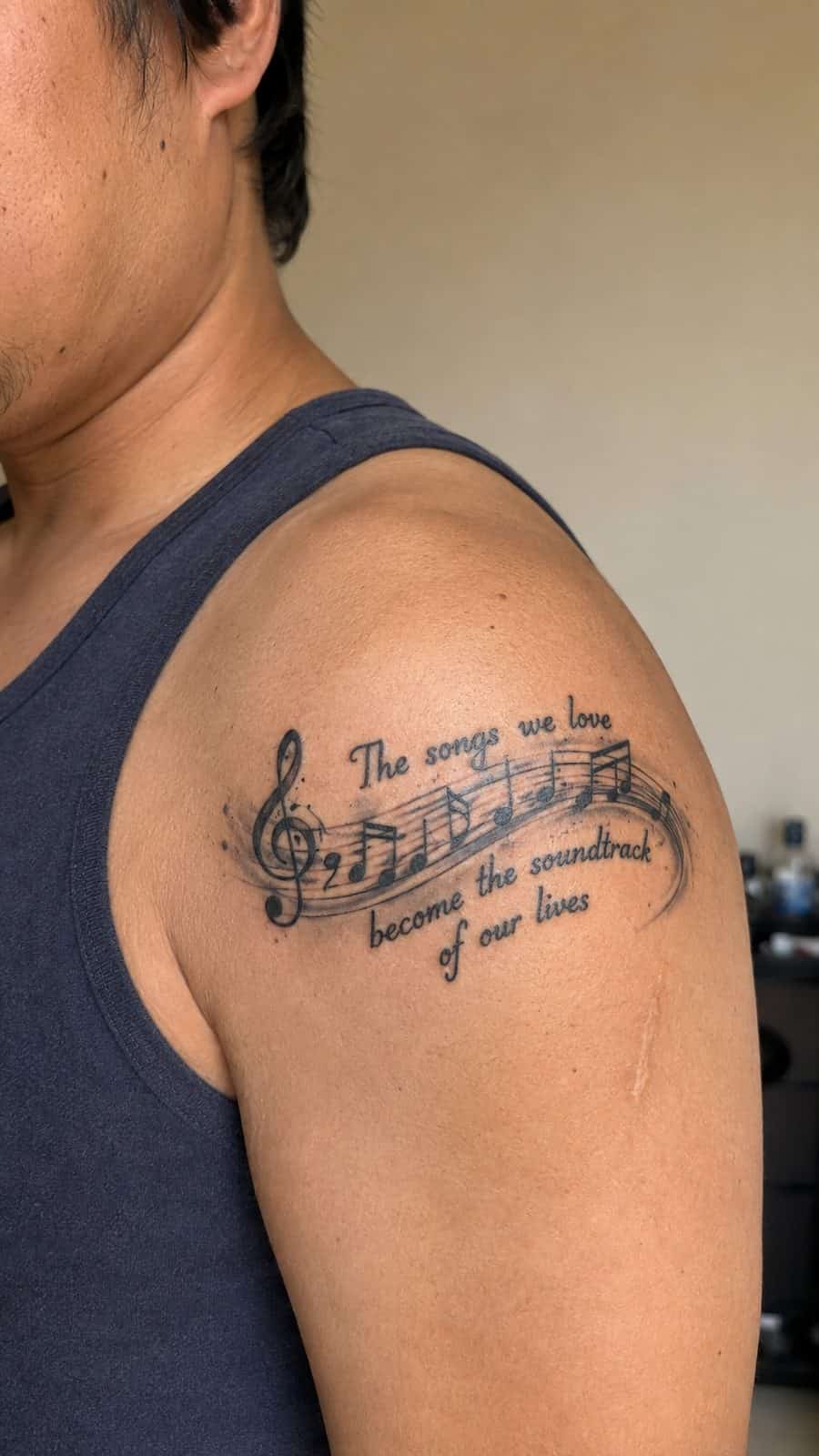 Healed music note and lyrics tattoo on a adult person's shoulder, photographed in a natural gentle side angle that clearly shows how — study 1