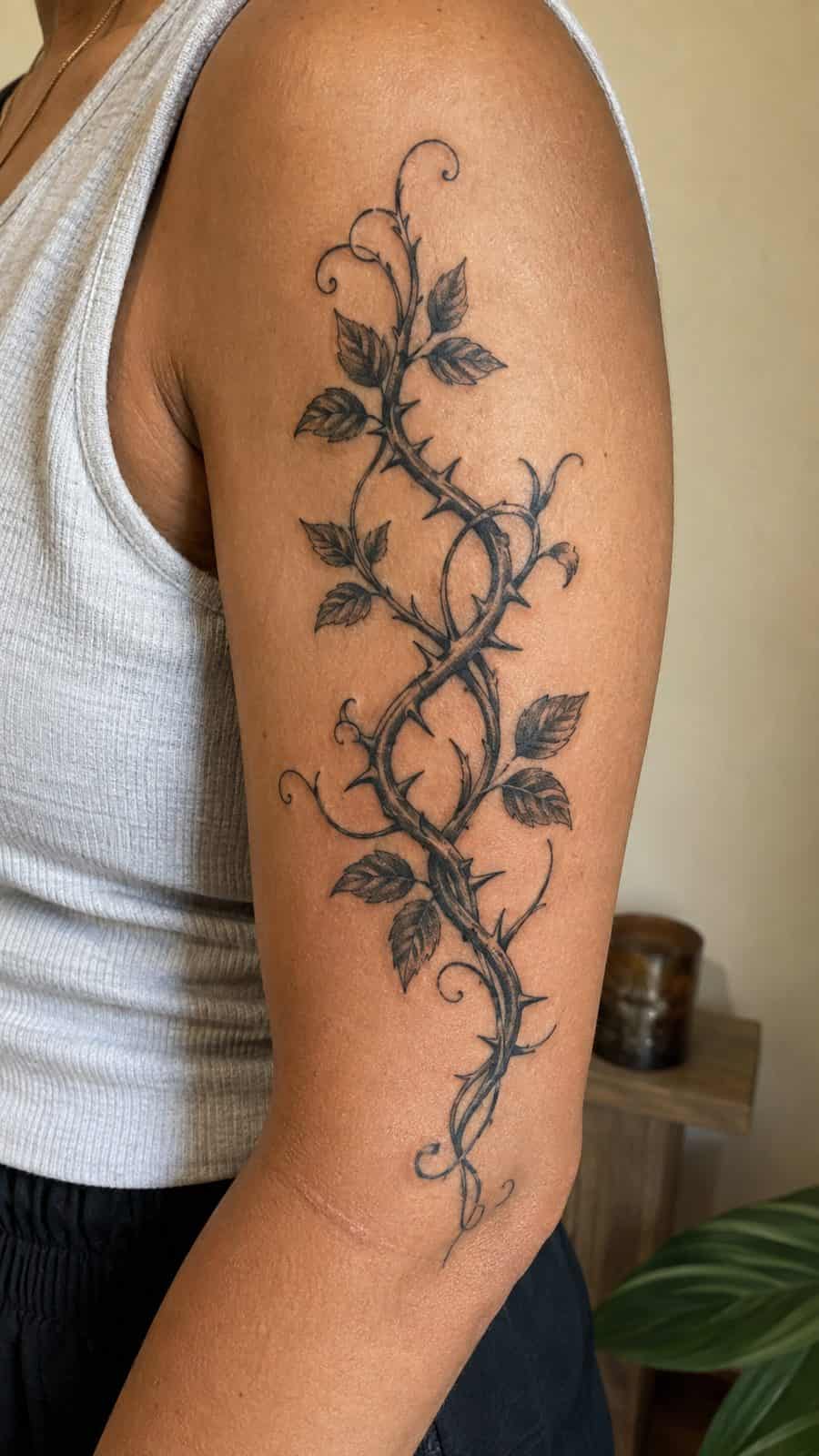 Healed vine and thorns tattoo on a adult person's outer upper arm, photographed in a natural waist-height candid close-up — study 2