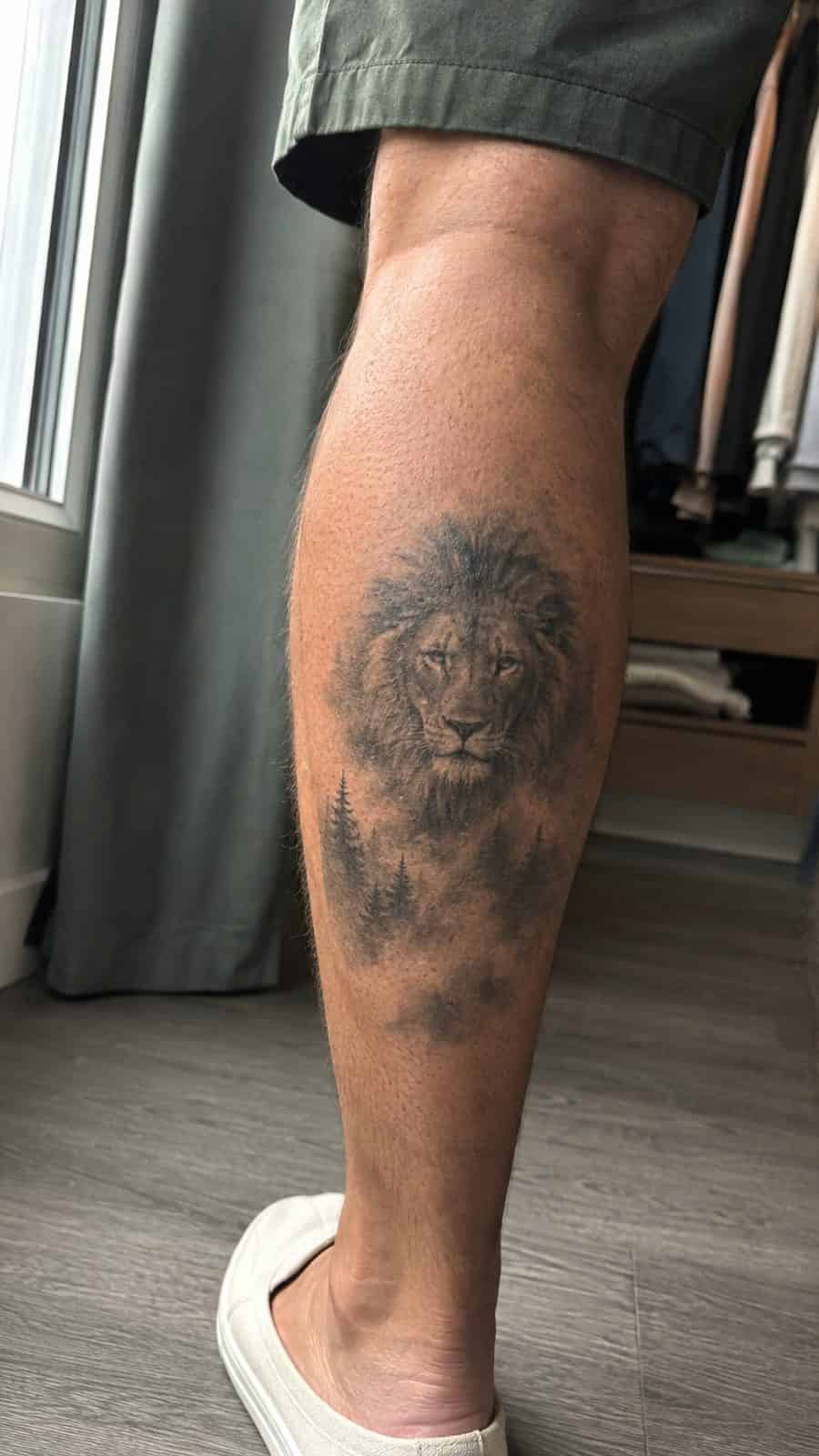 Unleash Your Inner Strength: 20 Male Lion Tattoo Ideas You Need to See 12 Healed lion in the mist tattoo on a adult man's outer calf, photographed in a natural casual close three-quarter view — study 1