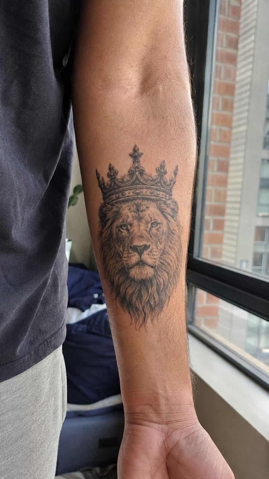 Unleash Your Inner Strength: 20 Male Lion Tattoo Ideas You Need to See 17 Healed crowned king tattoo on a adult man's inner forearm, photographed in a natural straight-on close view, a touch off-center like a — study 3