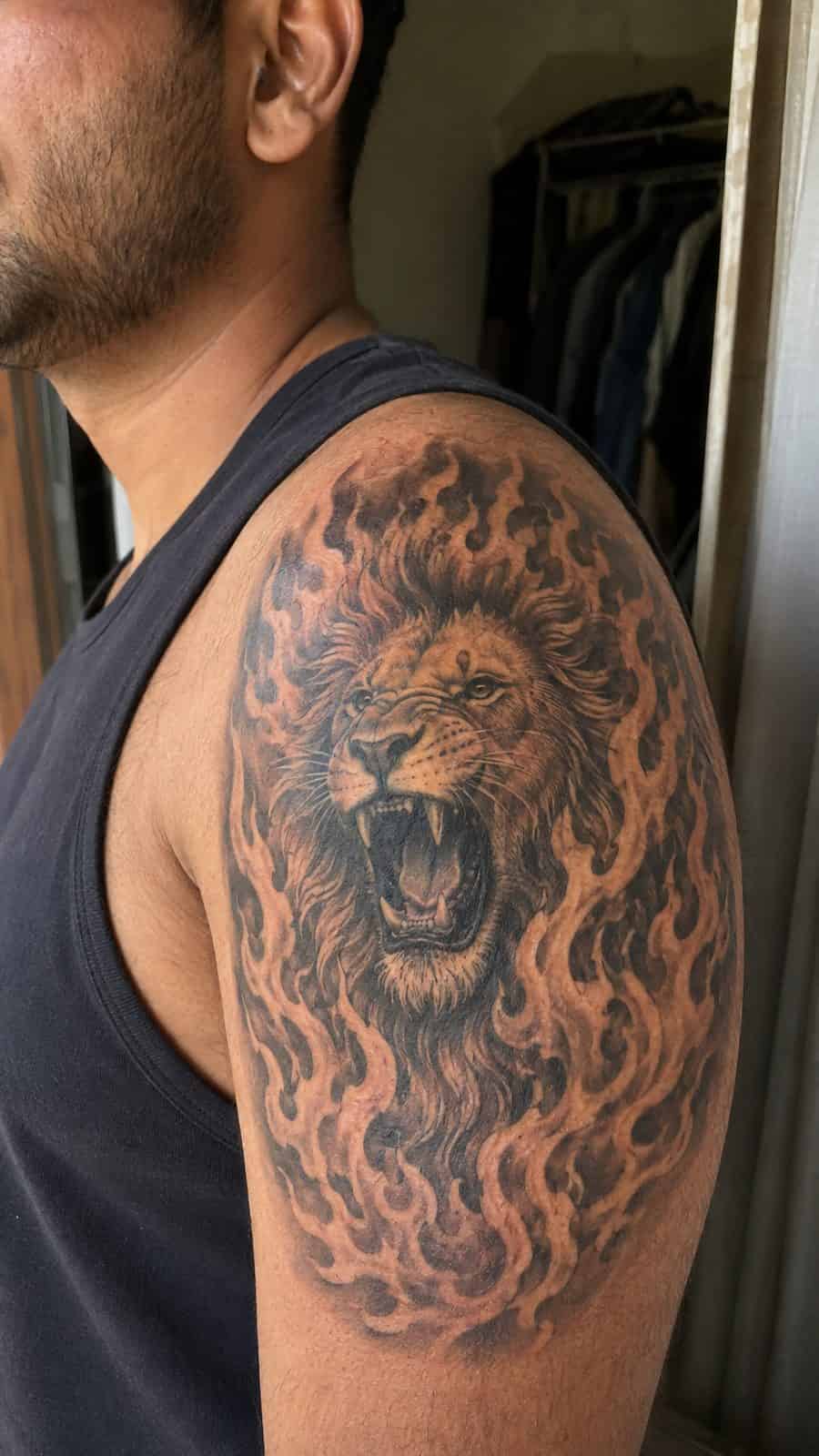 Unleash Your Inner Strength: 20 Male Lion Tattoo Ideas You Need to See 18 Healed roaring fire tattoo on a adult man's shoulder, photographed in a natural casual close three-quarter view — study 1