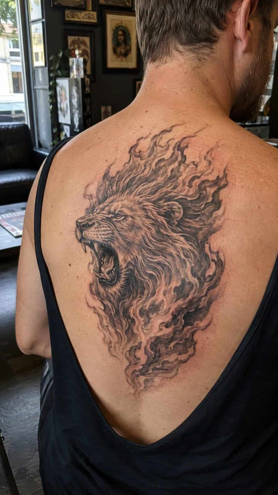 Unleash Your Inner Strength: 20 Male Lion Tattoo Ideas You Need to See 20 Healed roaring fire tattoo on a adult man's upper back, photographed in a natural gentle side angle that clearly shows how the ink — study 3