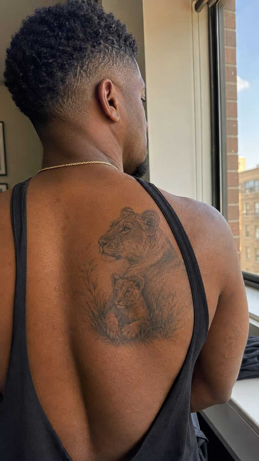 Unleash Your Inner Strength: 20 Male Lion Tattoo Ideas You Need to See 21 Healed guardianship tattoo on a adult man's upper back, photographed in a natural waist-height candid close-up — study 1