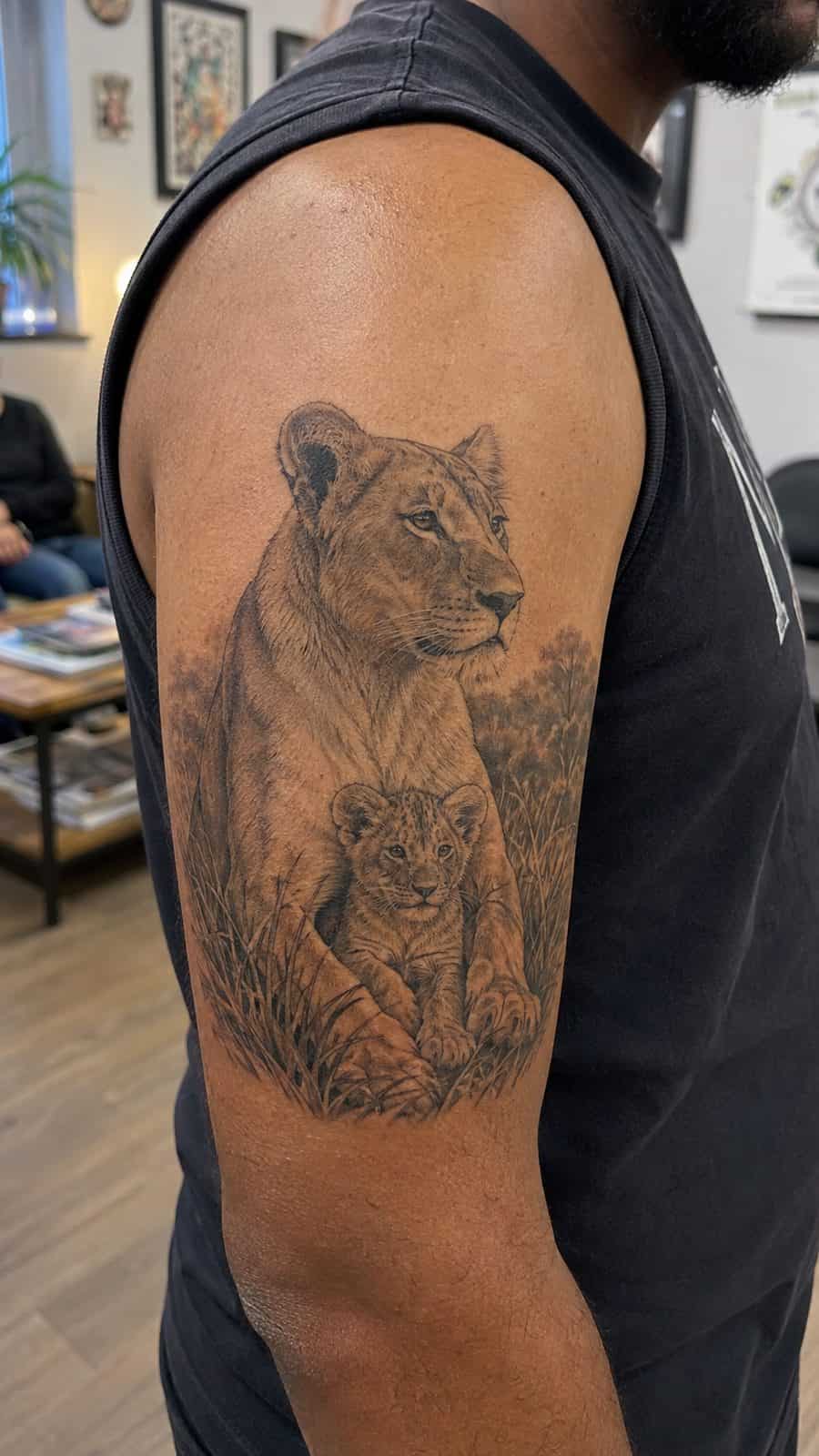 Unleash Your Inner Strength: 20 Male Lion Tattoo Ideas You Need to See 22 Healed guardianship tattoo on a adult man's outer upper arm, photographed in a natural relaxed documentary crop — study 2