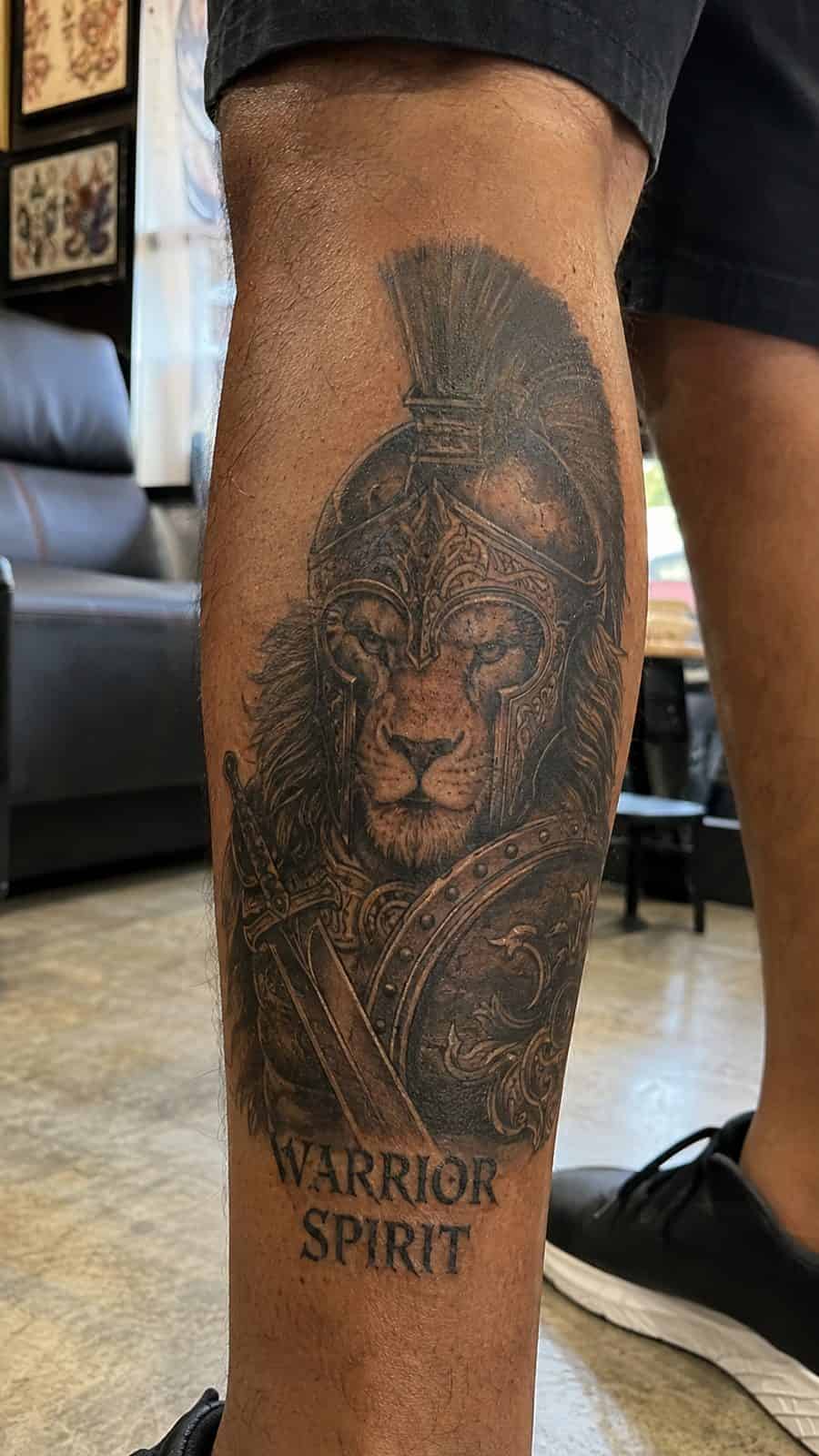 Unleash Your Inner Strength: 20 Male Lion Tattoo Ideas You Need to See 29 Healed warrior spirit tattoo on a adult man's outer calf, photographed in a natural straight-on close view, a touch off-center like a — study 1