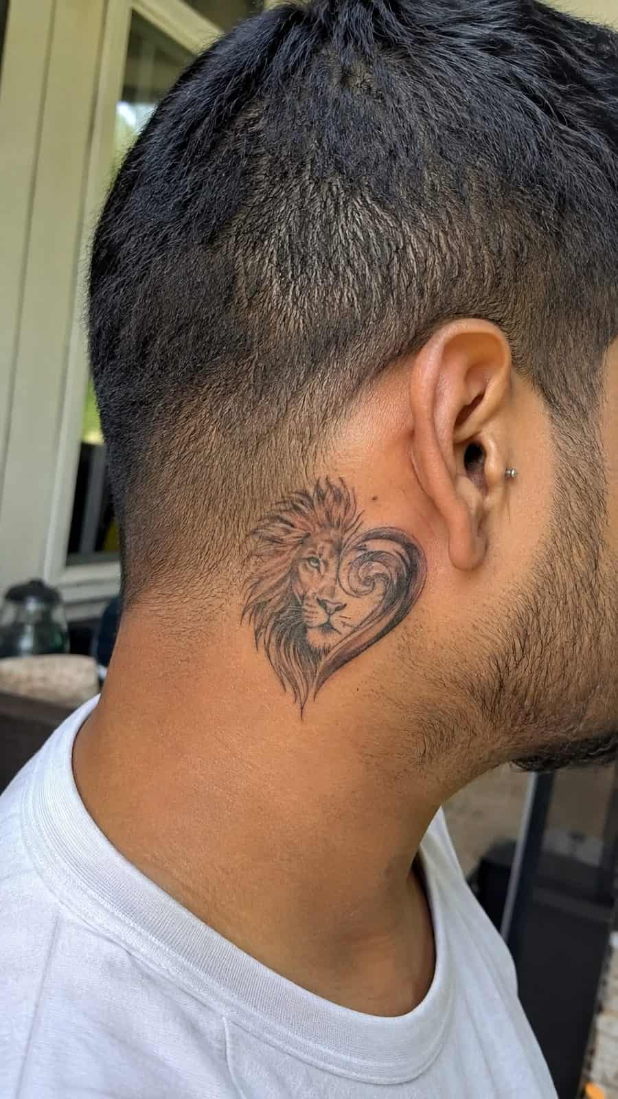 Unleash Your Inner Strength: 20 Male Lion Tattoo Ideas You Need to See 32 Healed lion's heart tattoo on a adult man's behind the ear, photographed in a natural gentle side angle that clearly shows how the ink — study 1