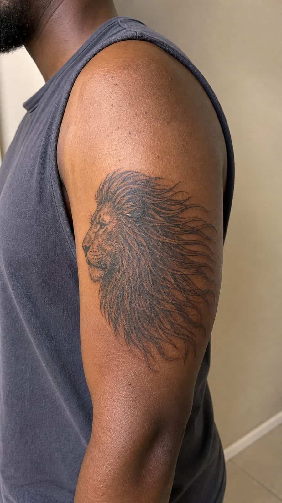 Unleash Your Inner Strength: 20 Male Lion Tattoo Ideas You Need to See 46 Healed mane in the wind tattoo on a adult man's outer upper arm, photographed in a natural relaxed documentary crop — study 1