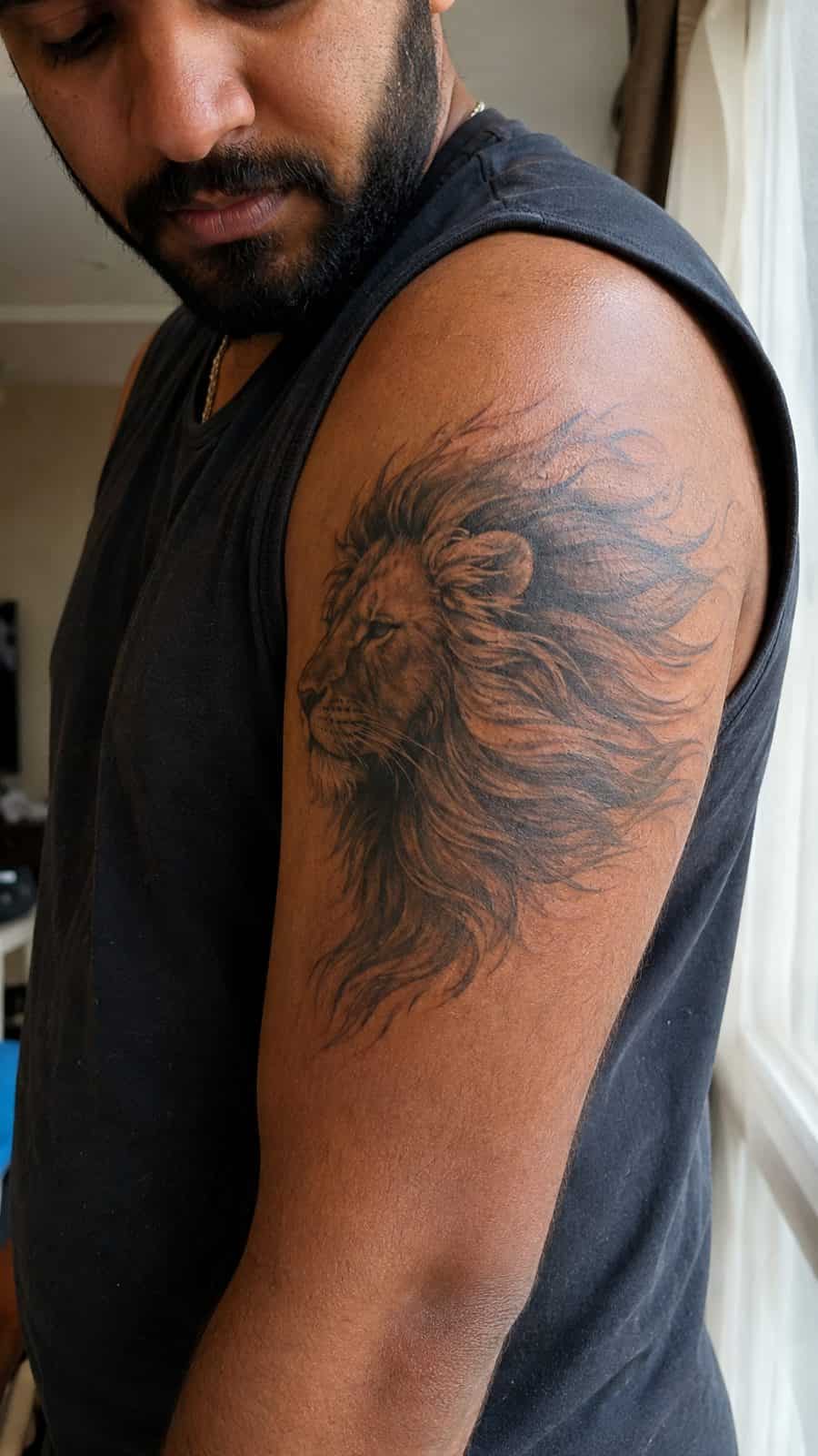 Unleash Your Inner Strength: 20 Male Lion Tattoo Ideas You Need to See 47 Healed mane in the wind tattoo on a adult man's outer upper arm, photographed in a natural casual close three-quarter view — study 2