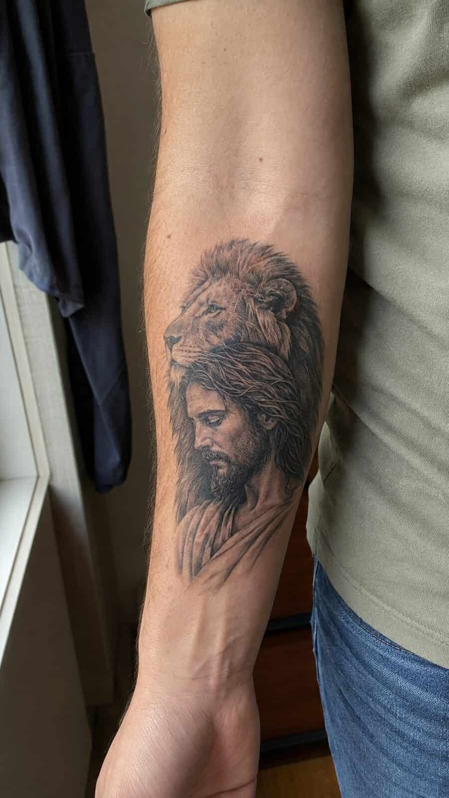 Exploring 18 Profound Jesus Tattoo Ideas for the Modern Man 27 Healed jesus and the lion tattoo on a adult man's inner forearm, photographed in a natural waist-height candid close-up — study 1