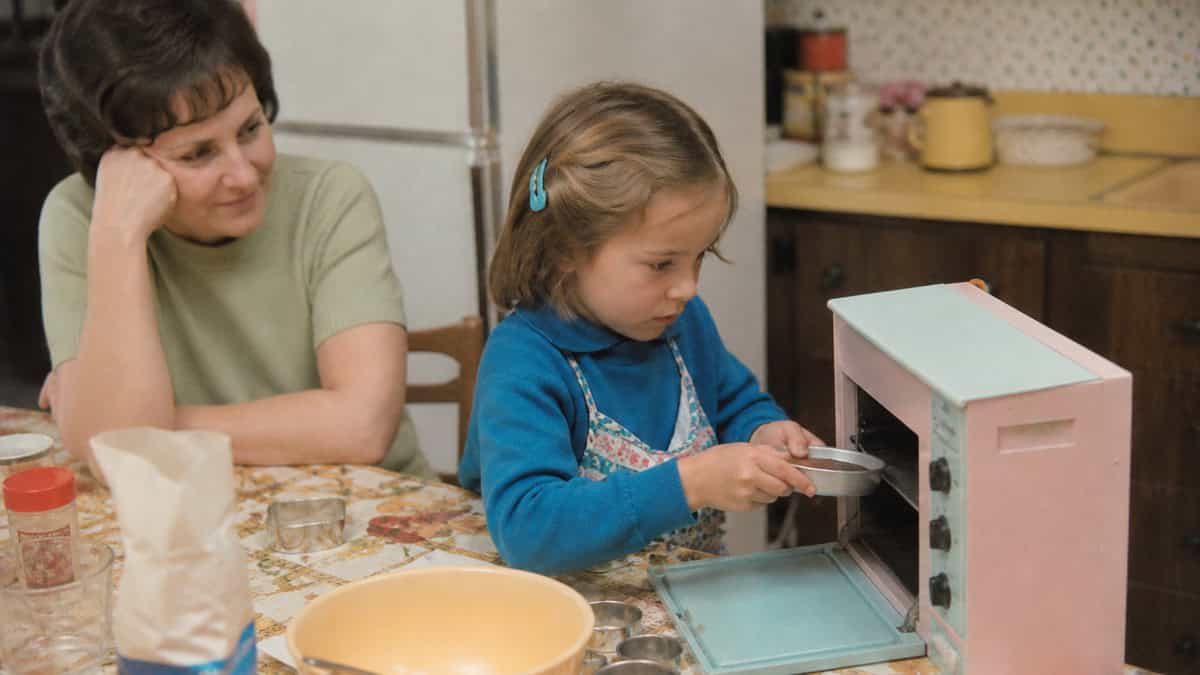 15 TV Commercials from Our Childhood That Would Be Banned Today 4 Child using a toy baking oven with a parent in the early 1970s