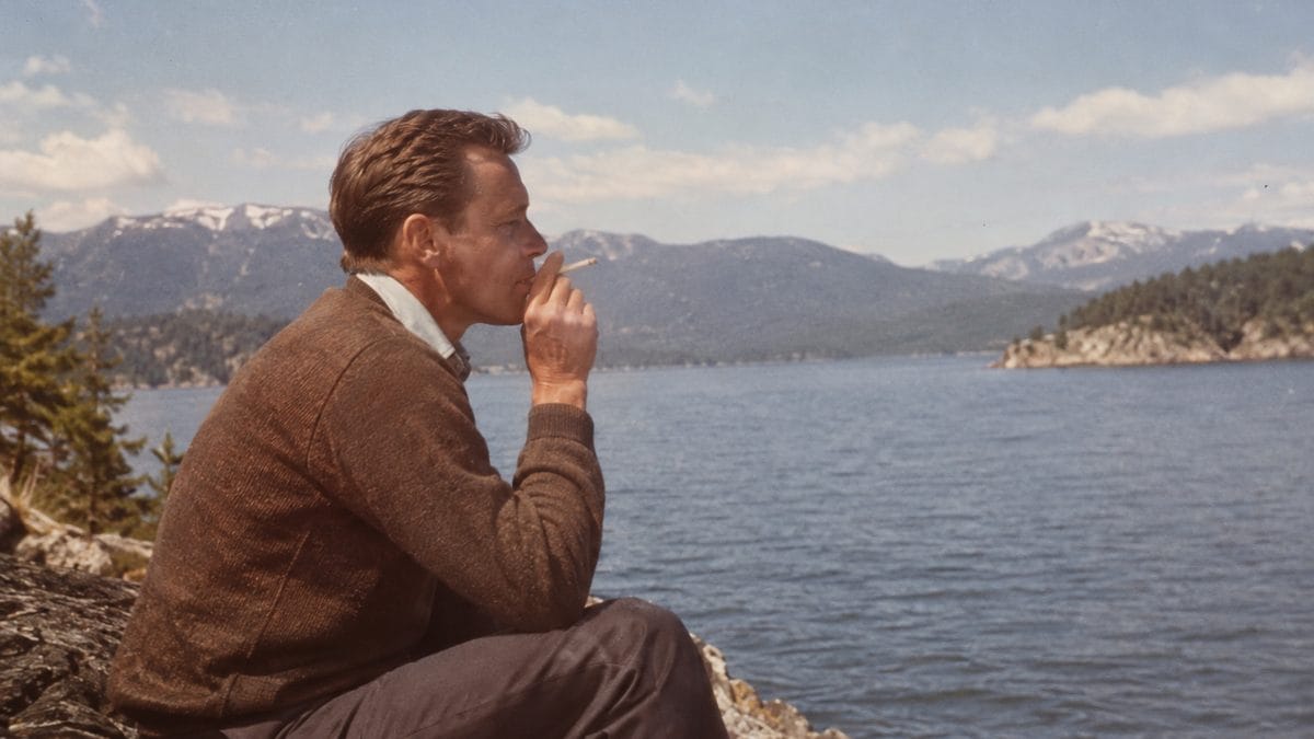 Genuine 1960s photo of a man smoking outdoors