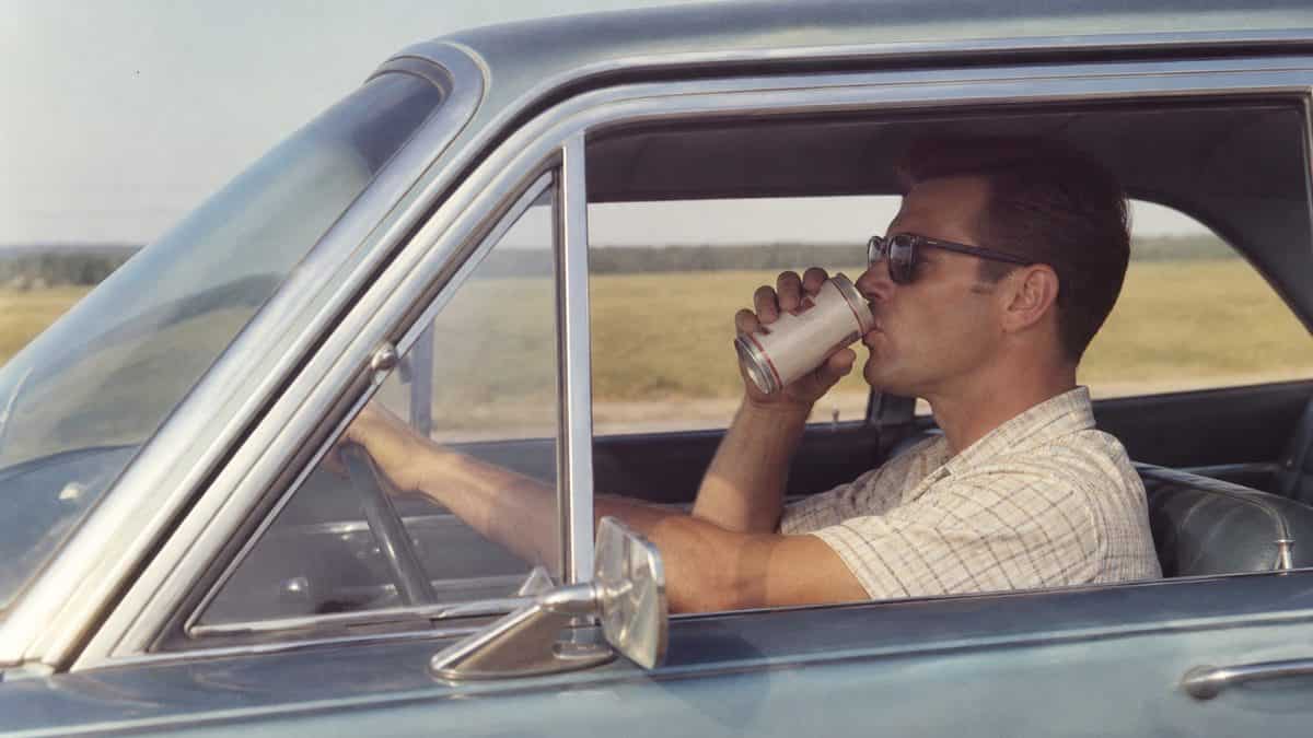 Driver with a beverage