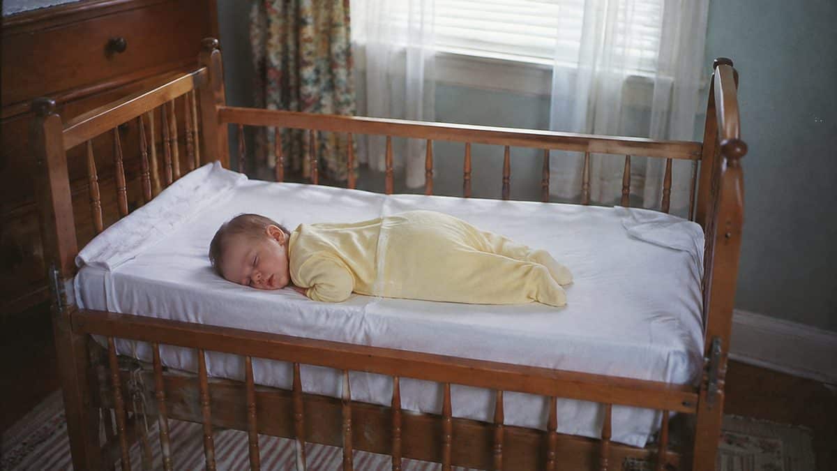 1960s Parenting Practices That Would Get CPS Called Today 9 Authentic 1960s snapshot of a baby sleeping in a drop-side crib