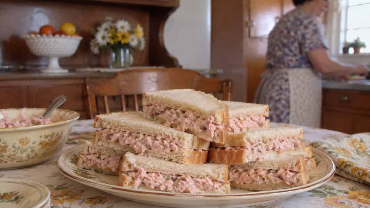 18 Church Potluck Recipes That Nobody Makes Anymore 4 Minced ham salad sandwiches on white bread.