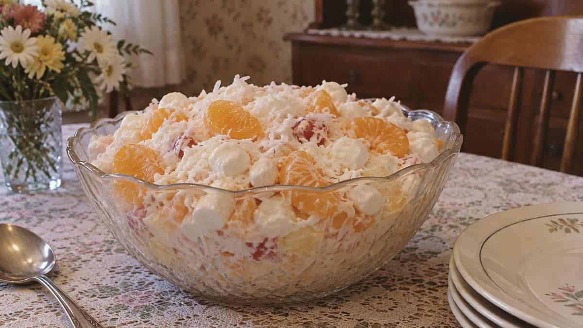 18 Church Potluck Recipes That Nobody Makes Anymore 7 Real ambrosia salad showing marshmallows, coconut, and mandarin oranges.